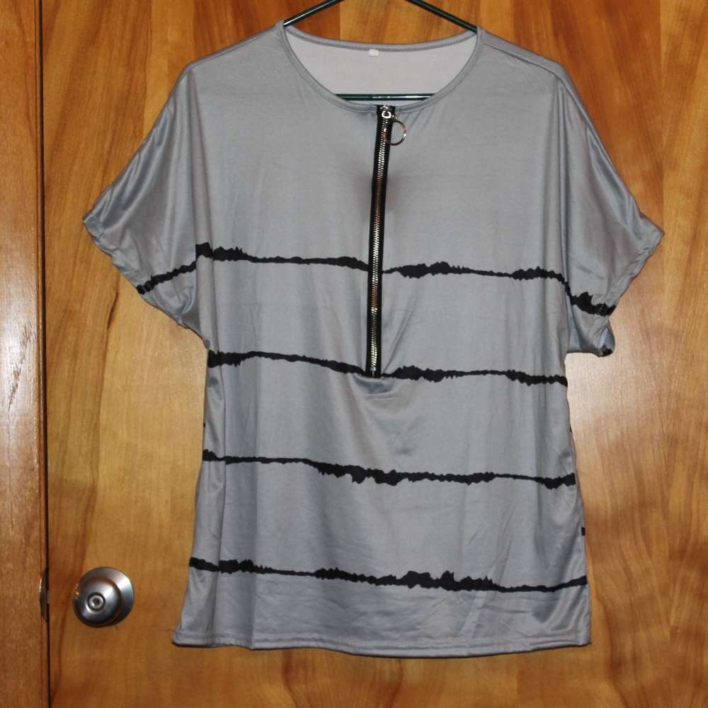 Gray top with black stripes and a zipper in front.